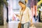 People use phone cellular in commercial center - cheerful pretty adult woman texting on smart phone during shopping activity -