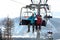 People using chairlift at mountain ski resort