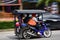 People using a tuk-tuk, it is a very common transport in the cit