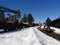 People, a view from the back, riding on a hand trolley, winter, narrow-gauge railway in the forest with pine and spruce, clear day