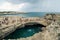 People visit Grotta Della Poesia swimming cave in Roca, Salento Peninsula, Italy