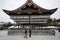 People visit wooden pavilion of main hall decorated with paper lanterns of Yasaka Shrine