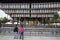 People visit wooden pavilion of main hall decorated with paper lanterns of Yasaka Shrine