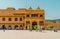 People visiting the Amber Fort in Jaipur India on a sunny day with mountains in the background