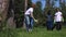 People volunteers family recycle plastic bottle collecting garbage for recycling and walking in green park on summer day