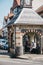 People waiting for a bus inside a retro bus stop hut on a high street in Sheringham, Norfolk, UK