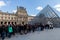 People Waiting in Long Queue at Louvre Museum in Paris France