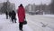 People are waiting for public transport at a bus stop in the city in a blizzard. Winter weather, slow motion