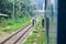 People are waiting in the rain for the train. It is a rainy railway station. University of Chittagong, Bangladesh railway station