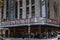 People waiting on a sidewalk near Radio City in New York, Manhattan.