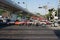 People waiting for a steam locomotive train to pass at a railroad crossing of Phetchaburi road