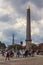 People waking in the largest square of Paris, Place de la Concorde with the Egyptian Obelisk of Luxor and Eiffel Tower in the