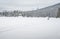 People Walk across Frozen Emerald Lake