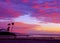 People walk along the beach with tidal inlet enjoying a glorious sunset, Del Mar, California