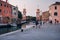 People walk along canal by Arsenal water gate. Venice, Italy during the coronavirus pandemic.