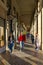 People walk along famous arcade on Rivoli Street, Paris, France