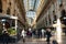 People walk along the Gallery of Vittorio Emanuele II - a unique indoor shopping gallery in the center of Milan, built in 1865-