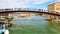 People walk along the pedestrian bridge across the Gran Canal in Venice Italy