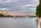 People walk along the Pushkinskaya embankment of Gorky Park against the background of the Moscow River and Andreevsky bridge, Mosc