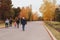 People walk on the asphalted road in the park overlooking Church of All Saints church on Mamayev Kurgan