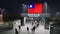 People walk through the border checkpoint gate to Taiwan at night - 3D rendered