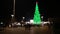 People walk in the city, December 31, New Year, Christmas. A large Christmas tree in the city center, garlands and