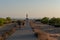 People walk down the street towards the Cap de Barbarie Lighthouse in Formentera in the summer of 2021