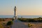 People walk down the street towards the Cap de Barbarie Lighthouse in Formentera in the summer of 2021