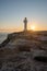 People walk down the street towards the Cap de Barbarie Lighthouse in Formentera in the summer of 2021