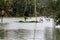 People walk through the flooded farms