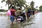 People walk through the flooded roads