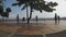 People walk girl bike couple stretch at lake boardwalk. silhouettes