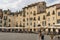 People walk and have a rest in cafes along Amphitheatre square.