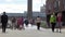 People walk on London Millennium Footbridge with the Tate Modern in the background.