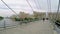 People walk on a pedestrian bridge across the river in Krasnogorsk