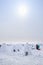 People walk on snow-covered lake among the igloos built for the contest, the traditional shelter of the northern peoples from