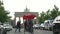 People walk take pictures ride bicycles at the Brandenburg Gate