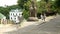 People walk in the territory of the Kiev-Pechersk Lavra near the monument.