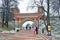 People walk towards an old bridge in Tsaritsyno park in Moscow