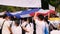 People walk under a large Thai flag