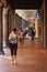 People walk under a long arcade