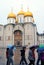 People walk under umbrellas by Dormition church