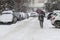 People walk on a very snowy sidewalk during snowstorm in the city of Sofia, Bulgaria â€“ feb 26,2018.