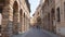 People walk in Via Pescheria, a street in Mantua city Center