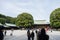 People walk through Wooden shrine Meiji Shinto in Shibuya Japan