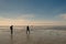 People walking across the large beach