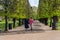 People walking along the alley on the garden of Rosenborg Castle in Copenhagen, Denmark