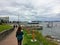 People walking along the boardwalk overlooking the ocean in the beautiful town of Sidney, British Columbia, Canada.