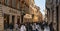 people walking along the elegant shopping avenue Via di Condotti in Rome