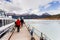 People walking along pier to enter boat to see glacier